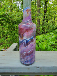 Decorative resin coated glass bottle