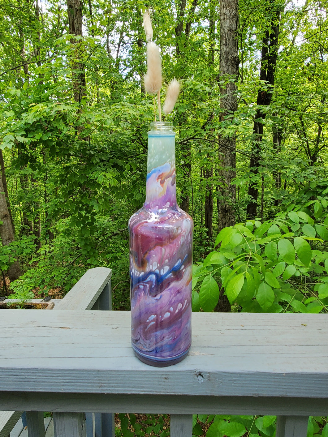 Decorative resin coated glass bottle